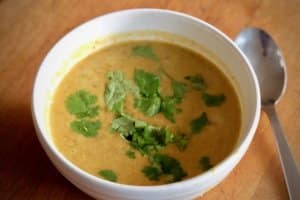 photo of Smoked roast butternut squash soup with sppon next to the bowl
