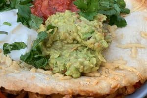 Guacamole close up photo of Guacamole on a quesadilla