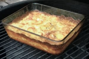 photo of Potato Dauphinoise in a glass dish on the bbq grill