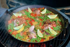 photo of chicken Paella in a pan on the bbq