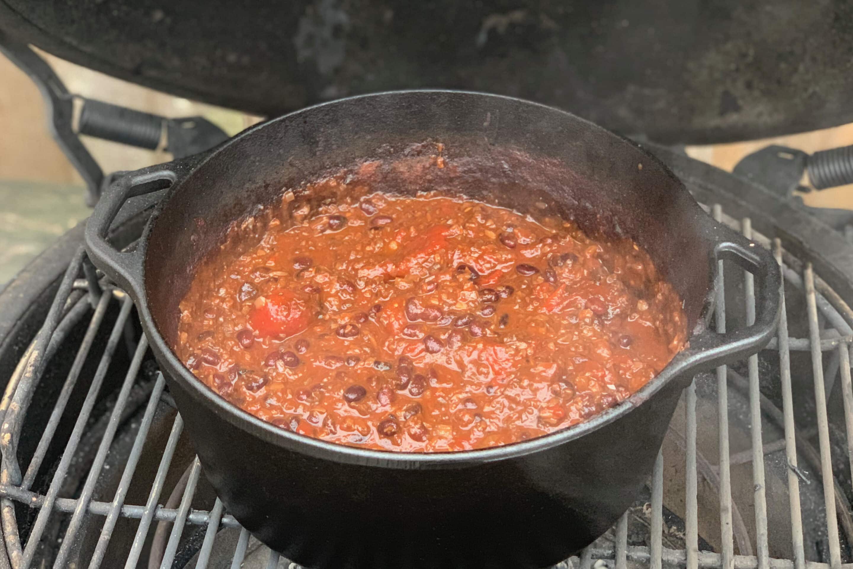 photo of large cast iron pot of Chilli con Mushroom on the bbq grill