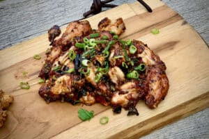 photo of a pile of Kung Pao Chicken Wings on a board