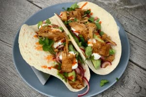photo of two Jackfruit Tacos on a grey plate