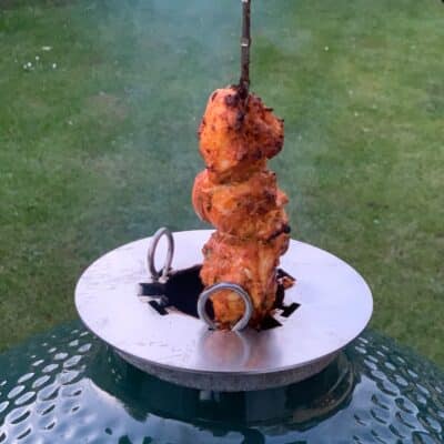 Photo of chicken tikka being cooked on the Big Green Egg using the LetzQ Tandoor Ring