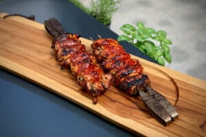 photo of two Korean Chicken Thigh Skewers on a board