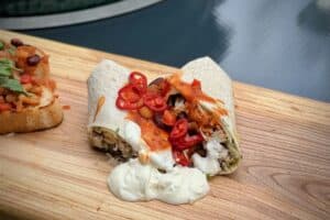 photo of Beer-braised chicken burrito on a baord