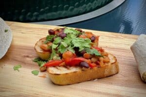 photo of Beer braised beans on toast on a baord