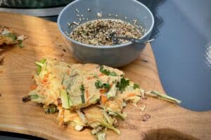 photo of Korean Pancakes with a dipping sauce on a board