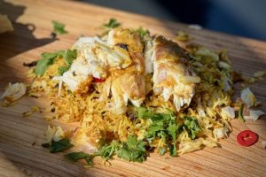 photo of Tandoori sea bass on rice on a board