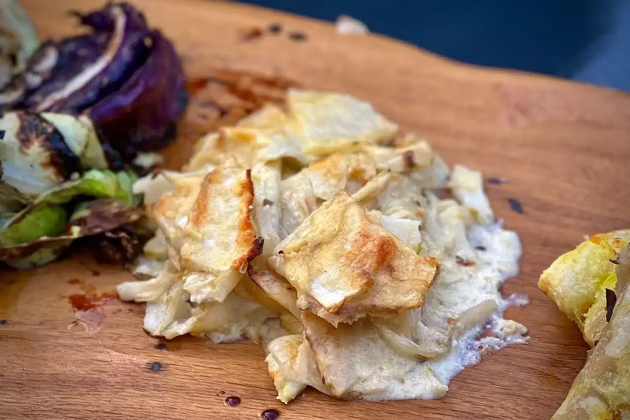 photo of a portion of Celeriac and fennel gratin on a board