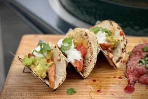 a photo of Shredded Chicken Tacos in a stand on a board