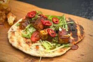 photo of a Spicy paneer flatbread on a board