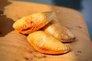 photo of three Spicy chicken empanadas on a board