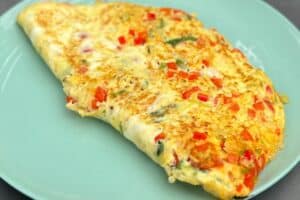 photo of Parsi Omelette folded in half on a green plate