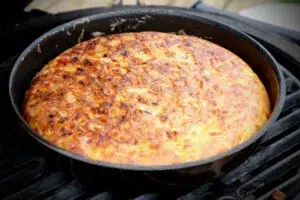 close up photo of Spanish Tortilla in a pan on a bbq grill