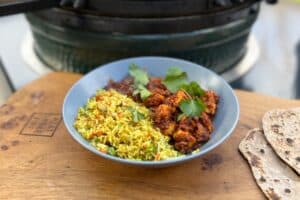 photo of Paneer Tikka Masala in a bowl next to a bbq