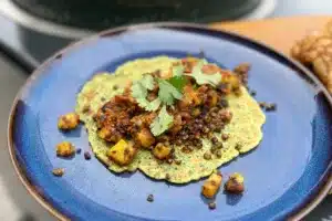 photo of Chickpea Pancakes and Spiced Potatoes on a blue plate