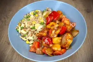 photo of Sweet and sour chicken in a grey bowl