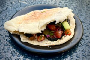 photo of Grilled Aubergine, Hummus, Tahini and Salad Pitta on a plate